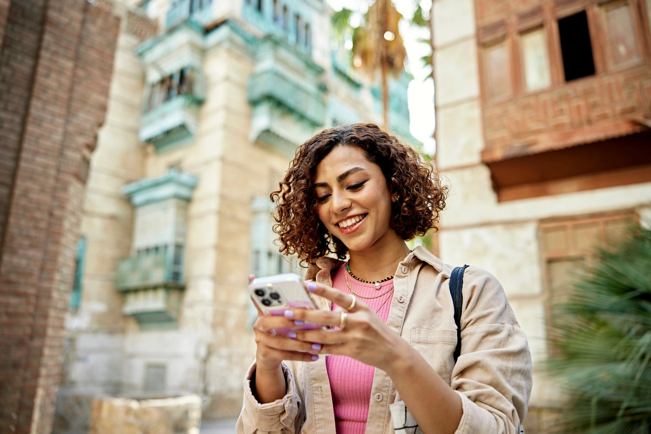Traveler checking destination info on a phone in a historic street