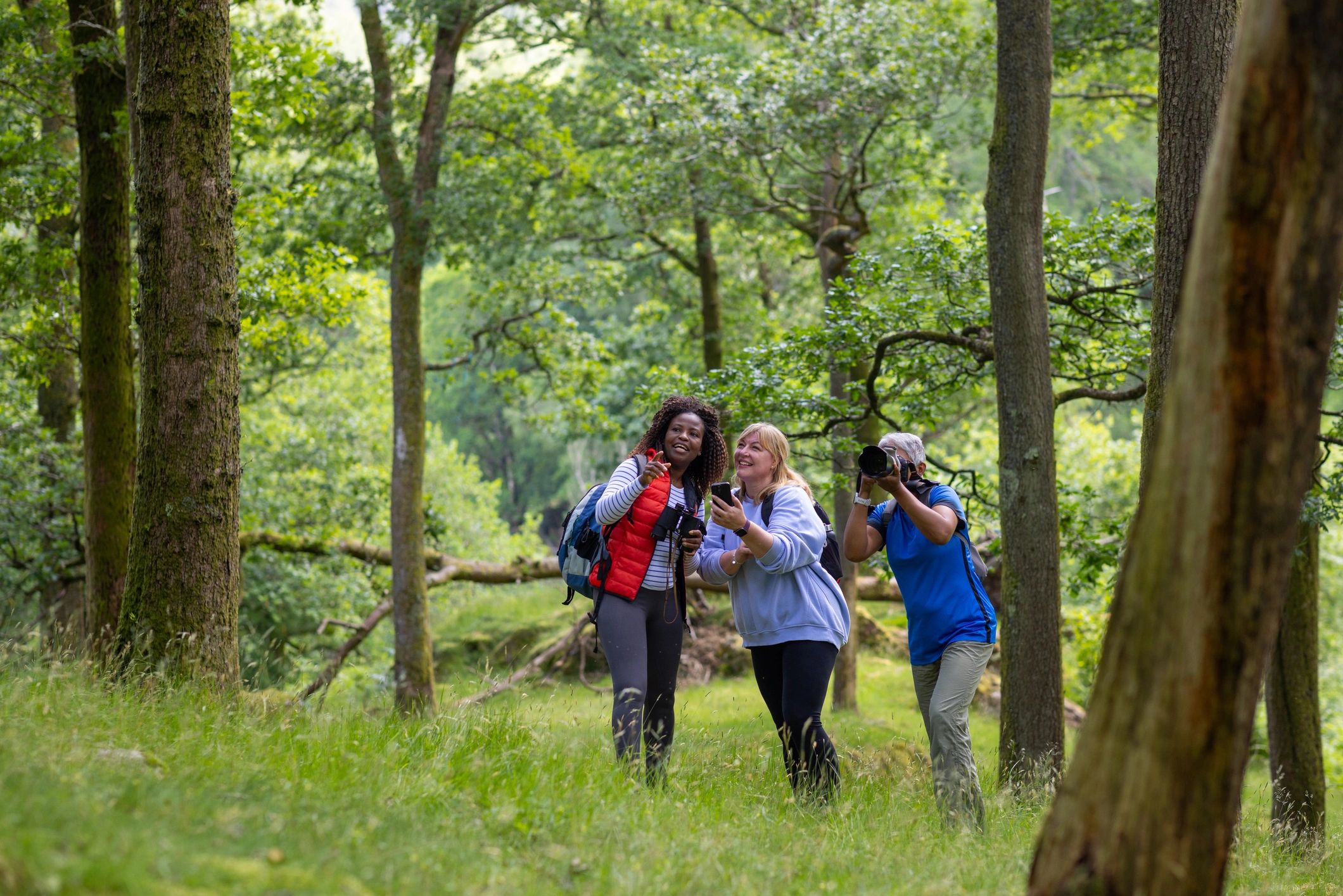 Backpackers outdoors comparing a map and travel app together